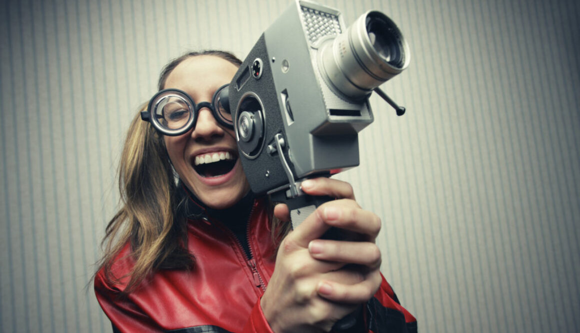 Nerdy woman with old fashion video camera