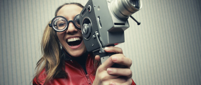 Nerdy woman with old fashion video camera