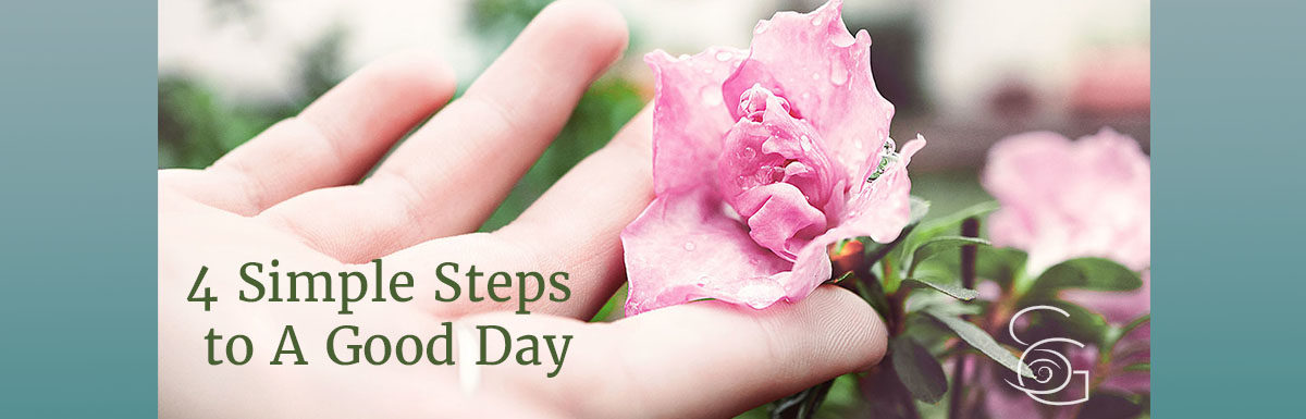 closeup hand touching pink rose 4 Simple Steps to A Good Day