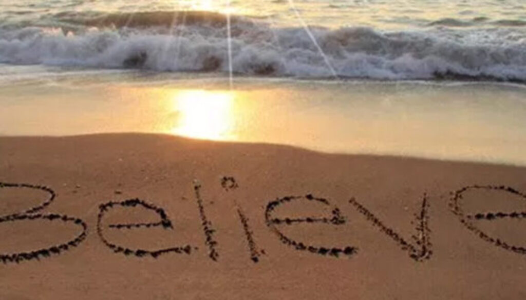 believe written in sand along beach shore