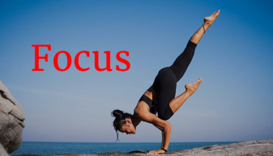 woman in yoga pose by ocean Focus concept
