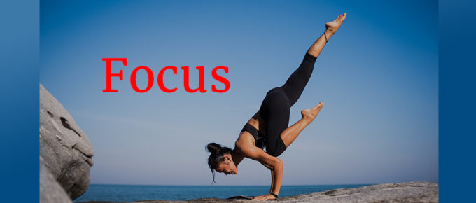 woman in yoga pose by ocean Focus concept